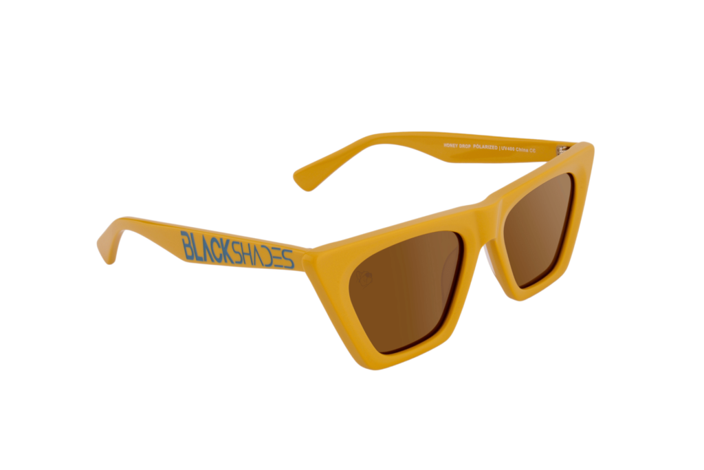 Product photo of Black Shades sunglasses, "Honey Drop," is a golden frame with amber lenses.