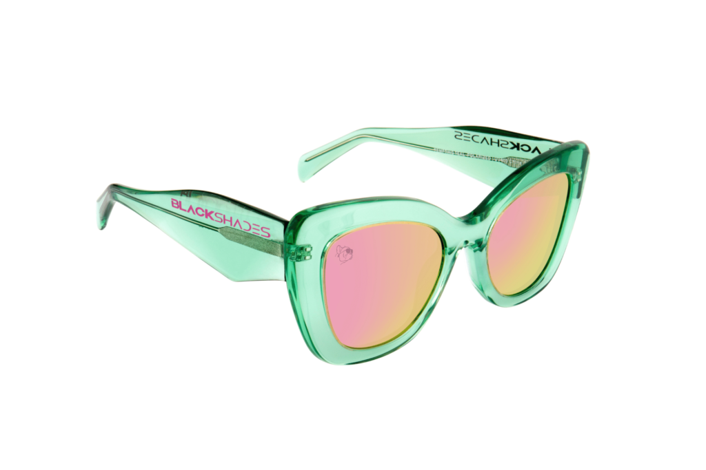 Product photo of Black Shades sunglasses, "Tempting Teal," is a teal frame with pink lenses.